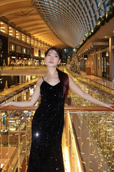 a lady in a black sequin sheath dress